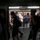 Protesters stand at a door of a subway train to disrupt its service at Fortress Hill station in Hong Kong, Aug. 5, 2019.